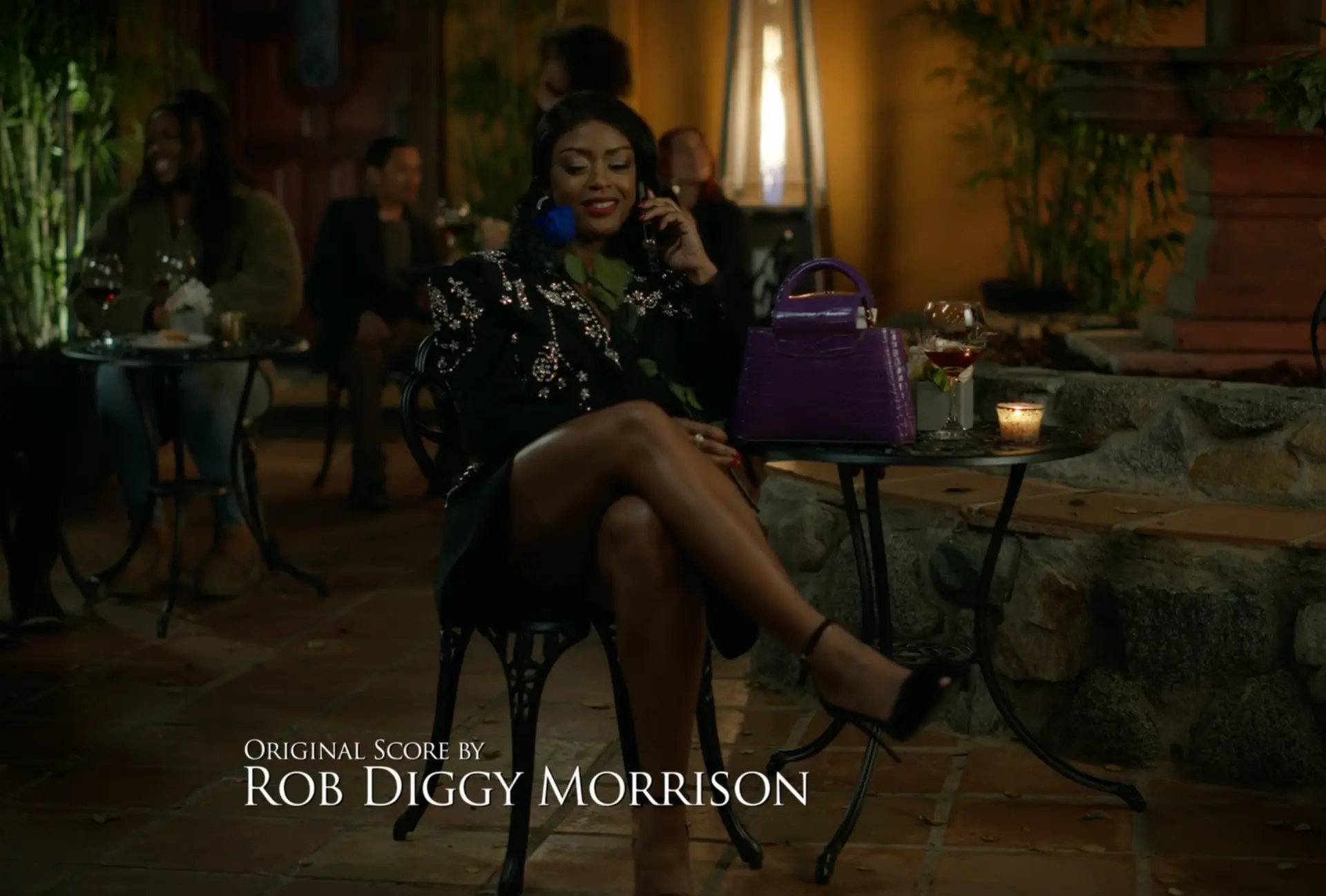 Original score by Rob Diggy Morrison end card over an evening patio scene