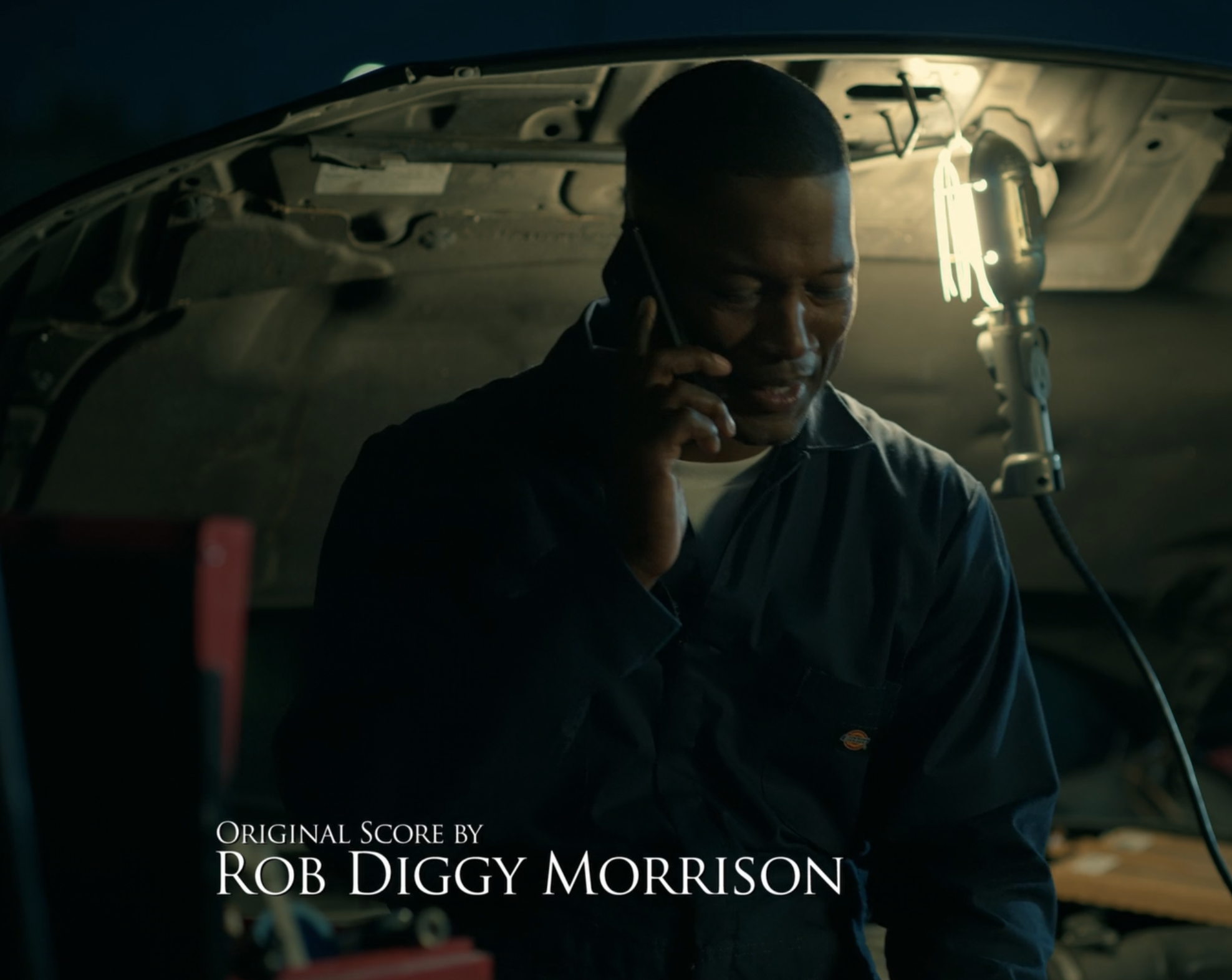 Original score by Rob Diggy Morrison end card over a night garage scene